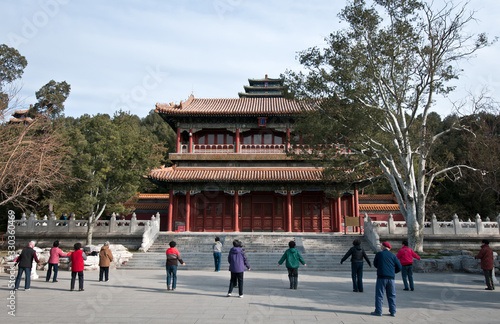 Group of Chinese people exercising in front of Qiwang Tower in Jingshan Park, Beijing in China