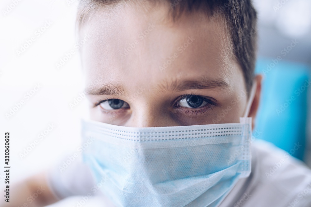 Sad boy in medical protective mask. Child during coronavirus epidemic Sad boy in medical protective mask. Child during coronavirus epidemic