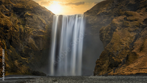 skogafoss waterfall in iceland at sunset