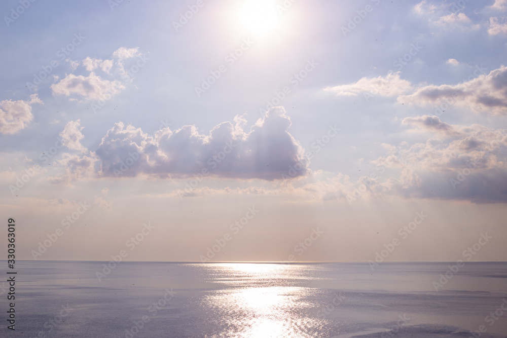 natural landscape sea and sky with clouds, path from the sun on the sea surface