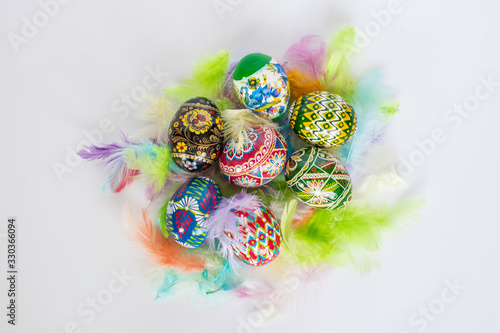 Colorful Easter eggs on colorful feathers