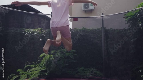 A girl jumping on a trampoline in slow motion