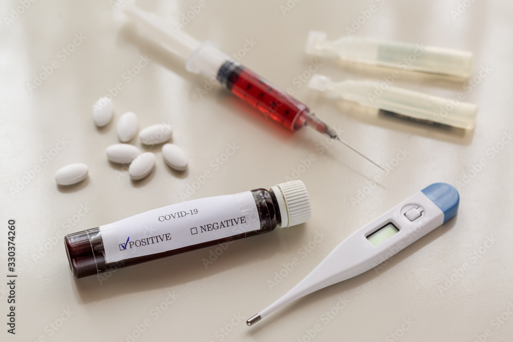 COVID-19 positive tube with syringe, thermometer, serum, and pills COVID-19 positive tube with syringe, thermometer, serum, and pills