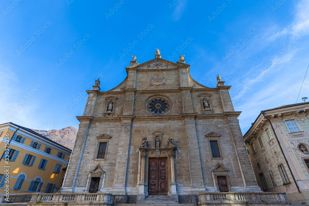 Close up front view of Collegiate of SS.Pietro e Stefano church with its imposing Renaissance facade with beautiful sculpture and decotation, in old town of Bellinzona, Ticino, Switzerland
