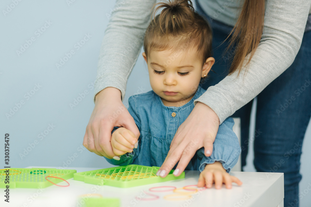 Teacher learn letters with little girl in kindergarden. Nursery Teacher learn letters with little girl in kindergarden. Nursery