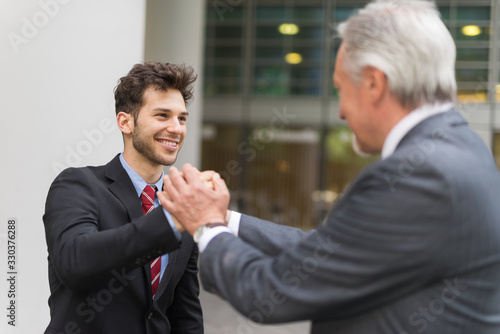 Boss holding the hands of an employee photo