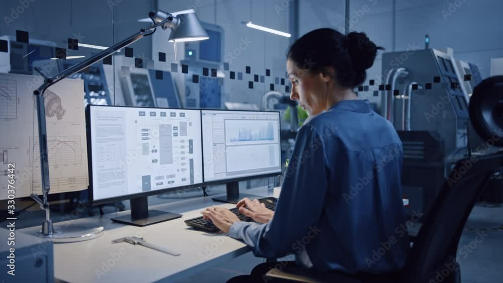 In Factory: Professionals Working on CNC Machinery, Walk Through Workshop, Use Digital Tablet, Manipulate Robot Arm Production Line. Female Engineer Controls System with Computer. Moving Camera In Factory: Professionals Working on CNC Machinery, Walk Through Workshop, Use Digital Tablet, Manipulate Robot Arm Production Line. Female Engineer Controls System with Computer. Moving Camera