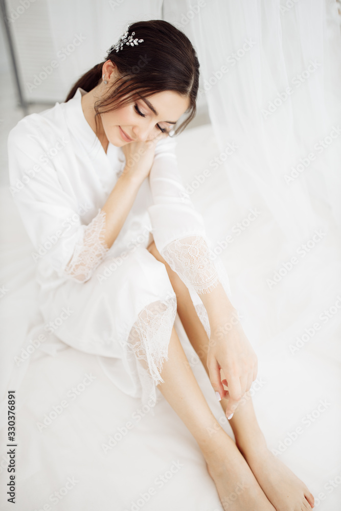 Elegant bride near the mirror at the morning Elegant bride near the mirror at the morning