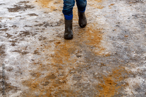 The ice on the road is sprinkled with sand so that it is not slippery. People confidently goes on the road, not afraid to fall.