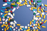 pills on a colored background top view. Medicine, treatment, illness. Medication in tablets.