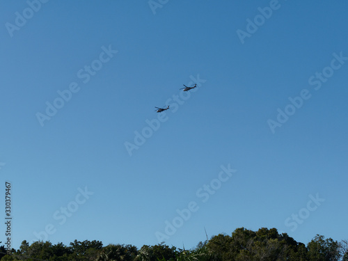 Silhouette Of two Helicopters at Clear Sky with tropical forest. Dominican Republic.. © Andrei
