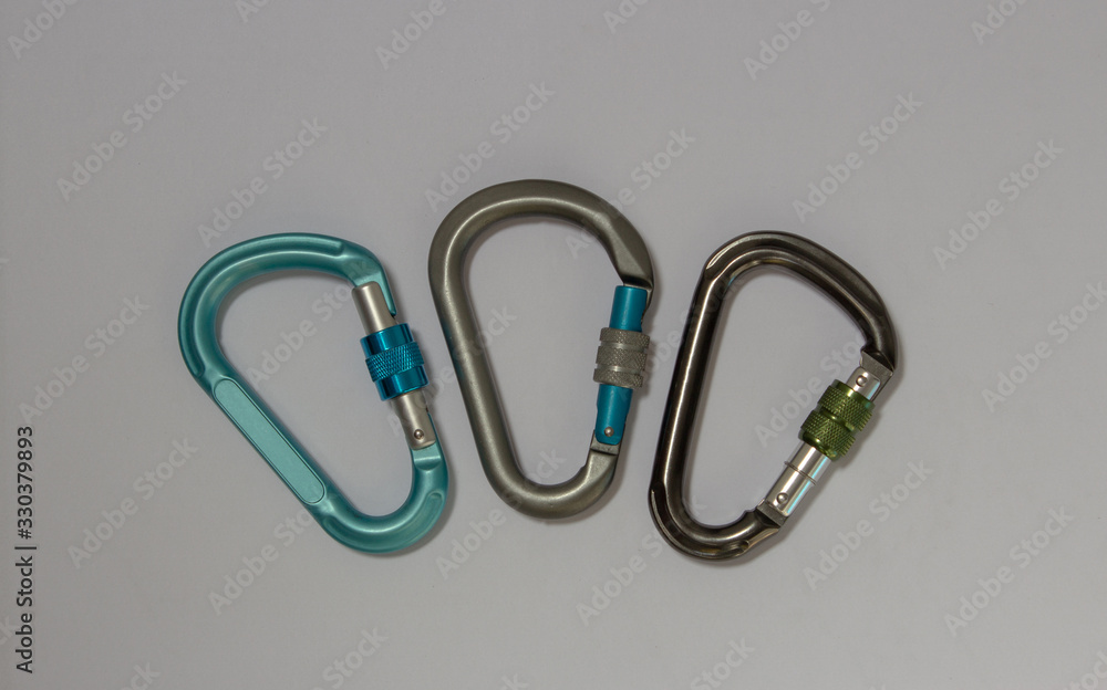 Tree pear shaped screw gate carabiners used in rock climbing Tree pear shaped screw gate carabiners used in rock climbing