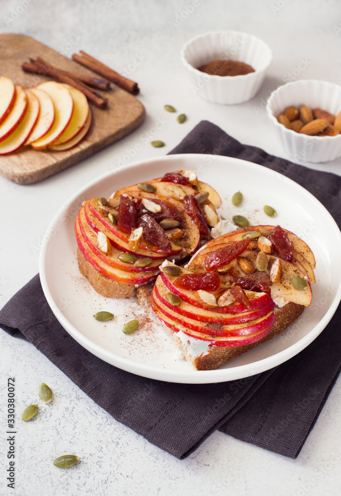 Open sandwiches with apple, jam, pumpkin seeds and almond close up. Open sandwiches with apple, jam, pumpkin seeds and almond close up.