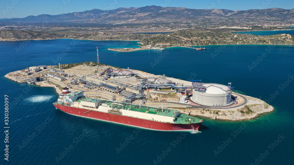 Aerial drone photo of small industrial islet and Natural Gas Terminal Station in Mediterranean, Elefsina, Greece