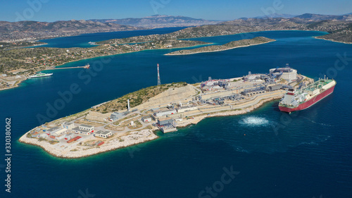 Aerial drone photo of of small industrial islet and Natural Gas Terminal Station in Mediterranean, Elefsina, Greece