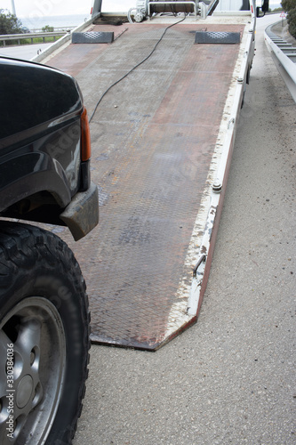 Loading broken car on a tow truck on a roadside