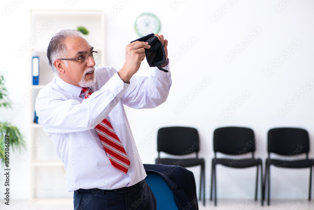 Old male accountant in budget planning concept Old male accountant in budget planning concept