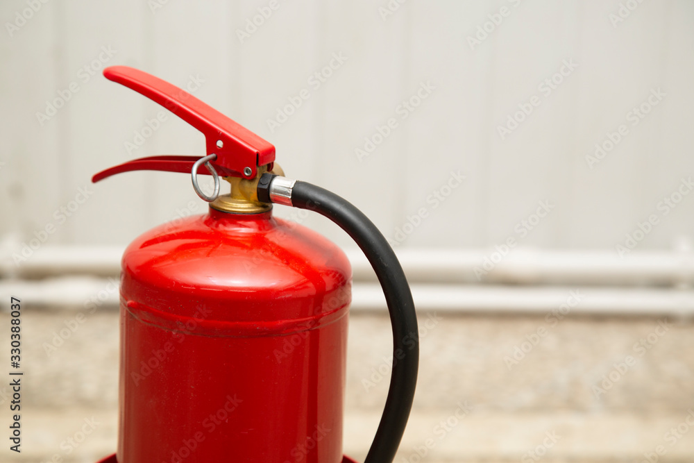 Red fire extinguisher on a white background. Fire extinguishing agent. Red fire extinguisher on a white background. Fire extinguishing agent.