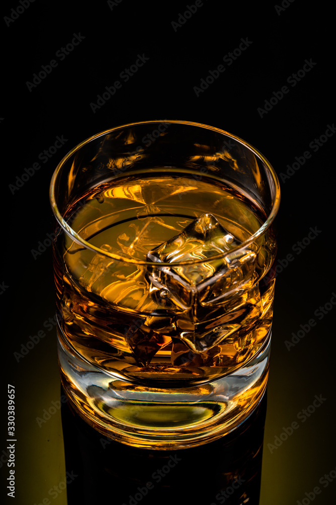 glass of whiskey on black background glass of whiskey on black background
