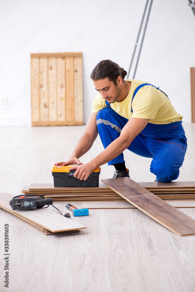 Young male contractor working indoors Young male contractor working indoors