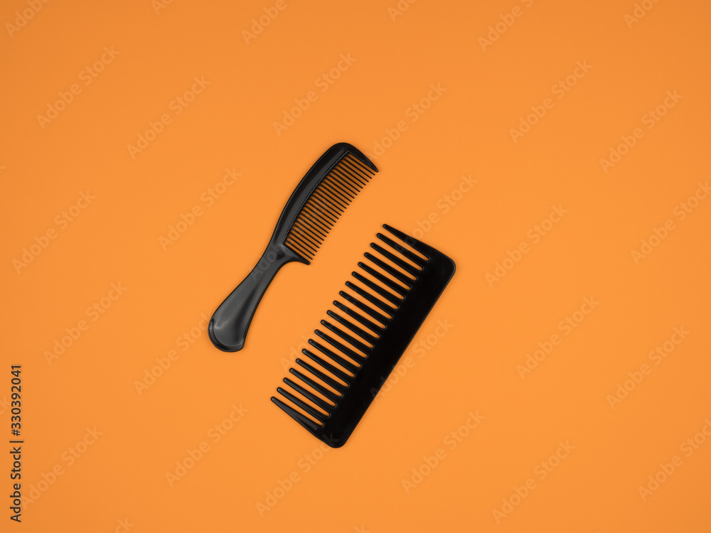 Hairdresser accessories comb hair on orange background. Hairdresser accessories comb hair on orange background.