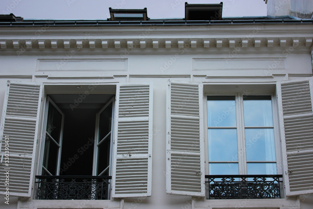 Window shutters and facade of a building in Paris, France