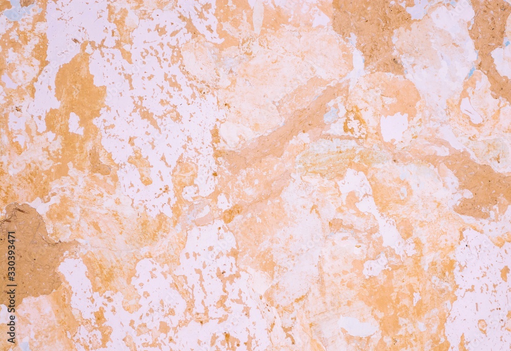Fototapeta premium Background of cracked clay wall covered with lime and paint.