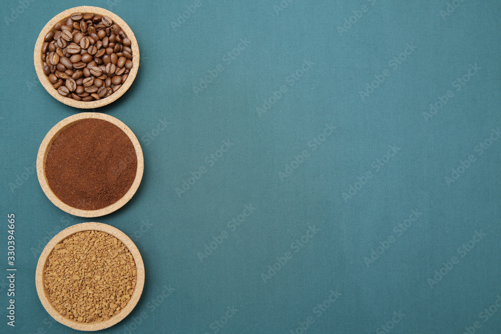 Coffee various - roasted beans or grain and ground and instant coffee on aqua ment or turquoise fabric background. The sequence of preparation of the drink Coffee concept. Flat lay Top view Copy space Coffee various - roasted beans or grain and ground and instant coffee on aqua ment or turquoise fabric background. The sequence of preparation of the drink Coffee concept. Flat lay Top view Copy space