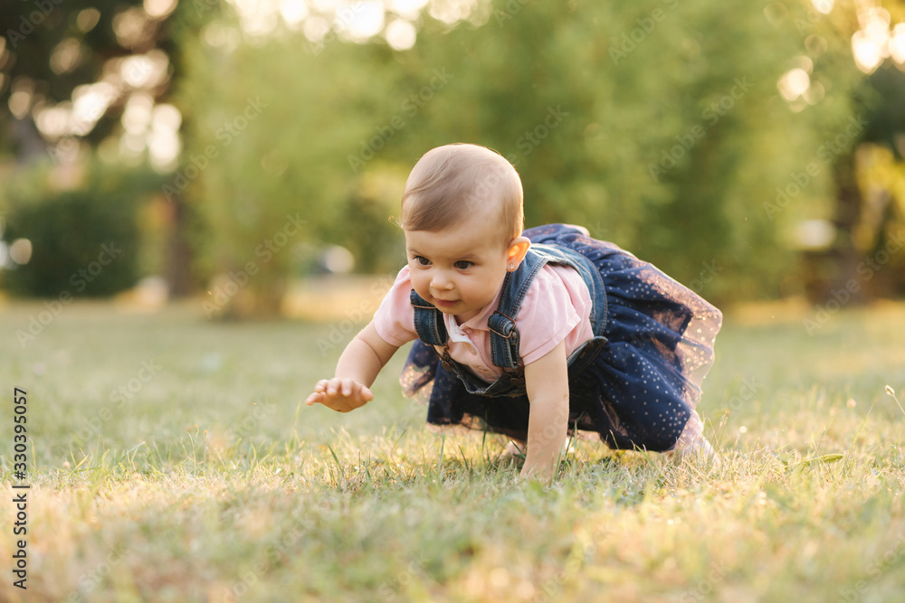 Little baby on grass in august. Adorable baby girl outside Little baby on grass in august. Adorable baby girl outside