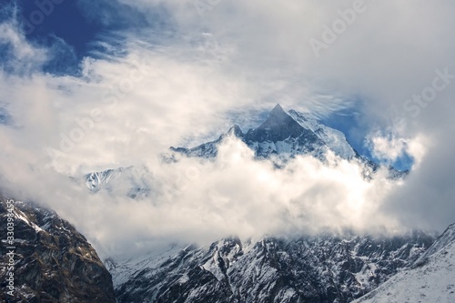 Machapuchare, Machhapuchchhre or Machhapuchhre Mountain Peak, also known as Fish Tail, Obscured by Clouds in Nepal Himalayas on Annapurna Base Camp Hiking or Trekking Route photo