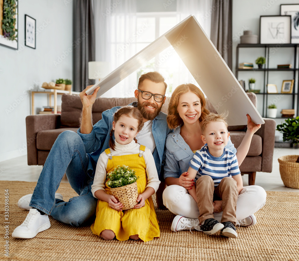 Happy family under fake roof in living room. Stock Photo | Adobe Stock