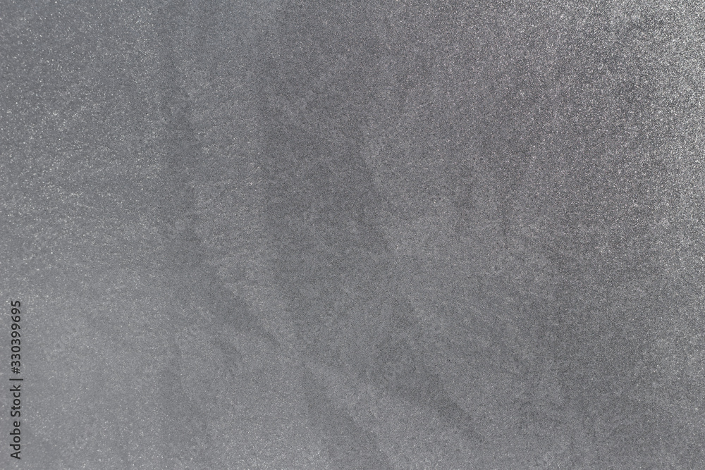 Crystal ice condensation patterns on a frosty glass window pane