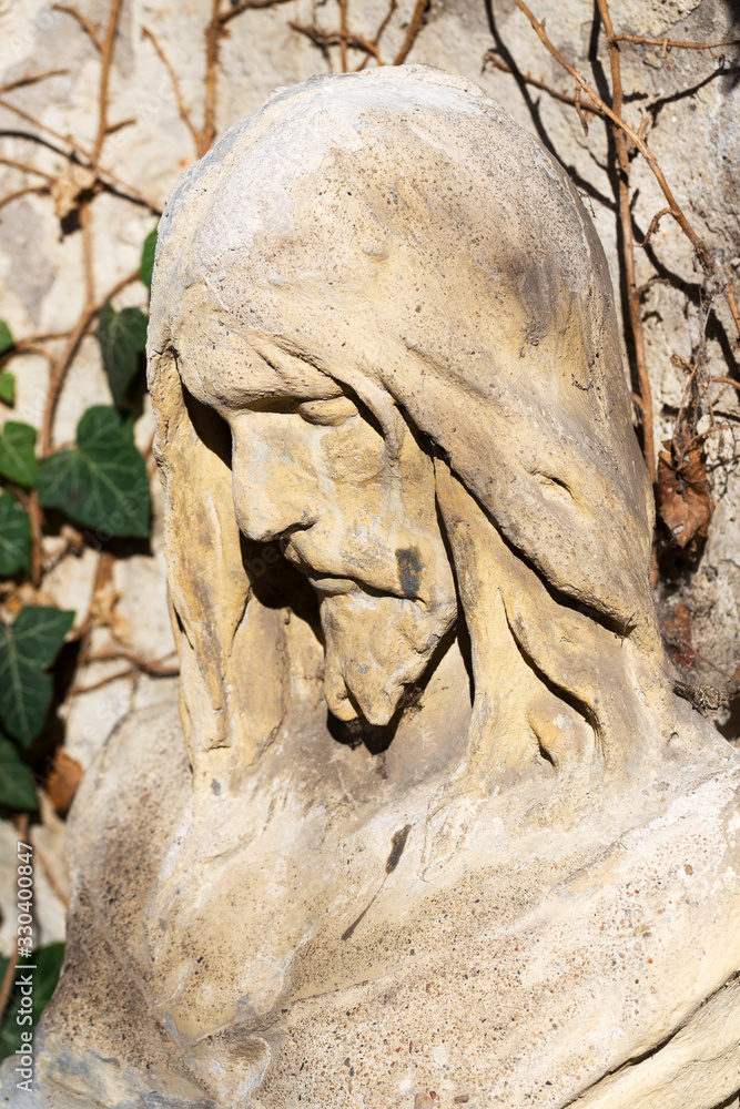 Fototapeta premium Historic Jesus on the mystery old Prague Cemetery, Czech Republic