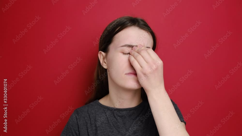 Ill allergic young woman sneezing, got flu concept or caught cold, having allergy symptoms, models over red background. Flu symptoms, N1H1 coronavirus, virus protection and chronic allergy concept Ill allergic young woman sneezing, got flu concept or caught cold, having allergy symptoms, models over red background. Flu symptoms, N1H1 coronavirus, virus protection and chronic allergy concept