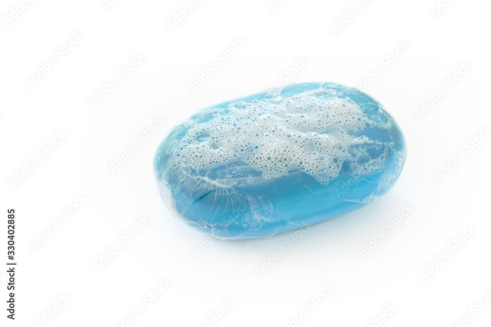 bar of blue soap with lather and bubbles isolated on a white background, health care and hygiene concept against corona virus infection, copy space bar of blue soap with lather and bubbles isolated on a white background, health care and hygiene concept against corona virus infection, copy space