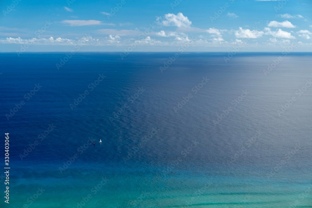A lone boat on the vast ocean, Waikiki, O'ahu Hawai