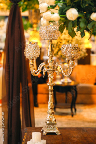 light chandeliers and decorative candles on defocused background