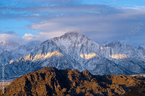 Mt. Whitney in the early morning with clouds around the peak 