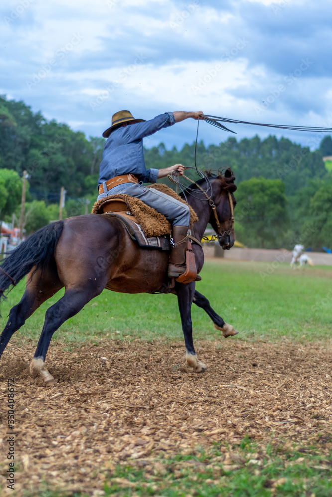 man riding a horse at a Creole rodeo man riding a horse at a Creole rodeo
