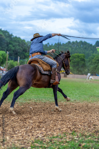 man riding a horse at a Creole rodeo "rodeio crioulo"