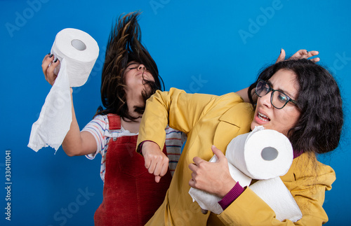 Women fighting for TP (toilet paper) amidst Coronavirus (Covid-19) pandemic; panic buying as epidemic spreads across the globe