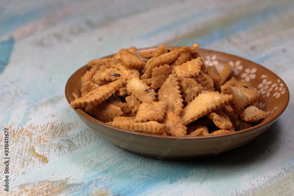 Namakpara (Khurma, Nimki, Mathri) which is a crispy, crunchy and savory strips in a bowl. Namakpara (Khurma, Nimki, Mathri) which is a crispy, crunchy and savory strips in a bowl.