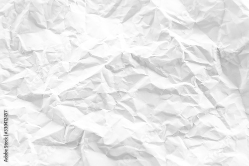 white and gray crumpled paper texture background. crush paper so that it becomes creased and wrinkled.