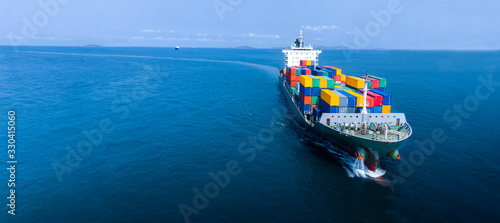Aerial in front of cargo ship carrying container and running for export  goods  from  cargo yard port to custom ocean concept smart freight shipping by ship , webinar banner.  forwarder mast photo