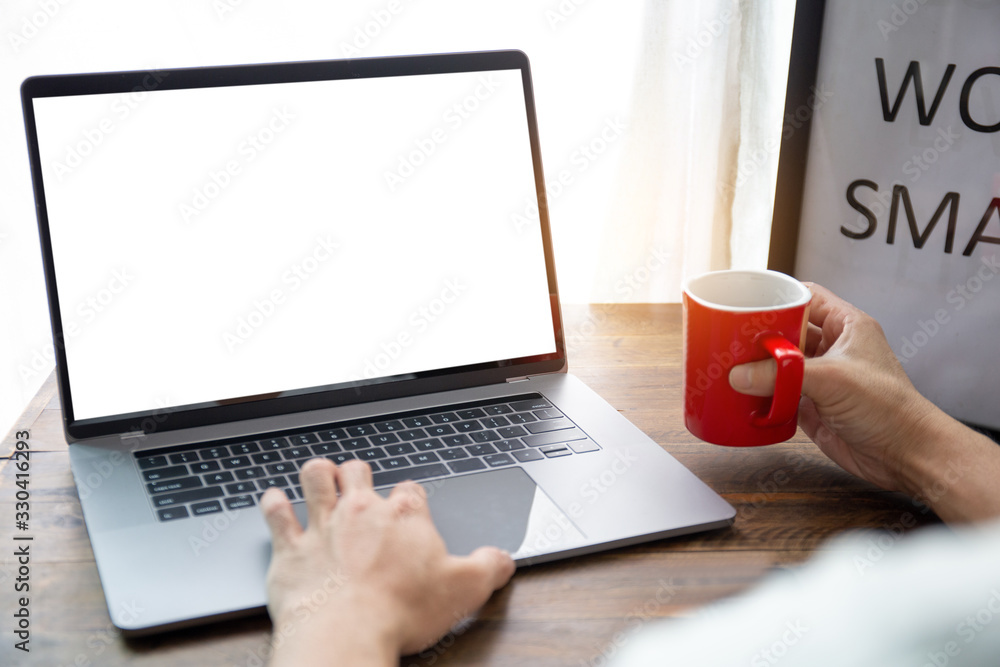 mockup image blank screen computer with white background for advertising text,hand man using laptop contact business search information on desk at coffee shop.marketing and creative design mockup image blank screen computer with white background for advertising text,hand man using laptop contact business search information on desk at coffee shop.marketing and creative design