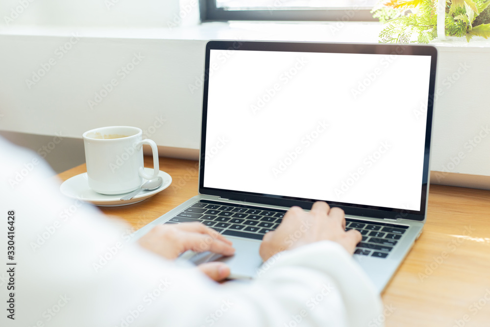 mockup image blank screen computer with white background for advertising text,hand woman using laptop contact business search information on desk at coffee shop.marketing and creative design mockup image blank screen computer with white background for advertising text,hand woman using laptop contact business search information on desk at coffee shop.marketing and creative design