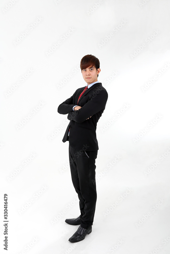 Young smart handsome Asian man business office wearing suit tie on white background stand side hands folded look at camera Young smart handsome Asian man business office wearing suit tie on white background stand side hands folded look at camera