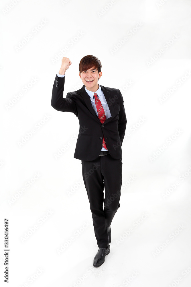 Young smart handsome Asian man business office wearing suit tie on white background look at camera walk forward fist up joy success Young smart handsome Asian man business office wearing suit tie on white background look at camera walk forward fist up joy success