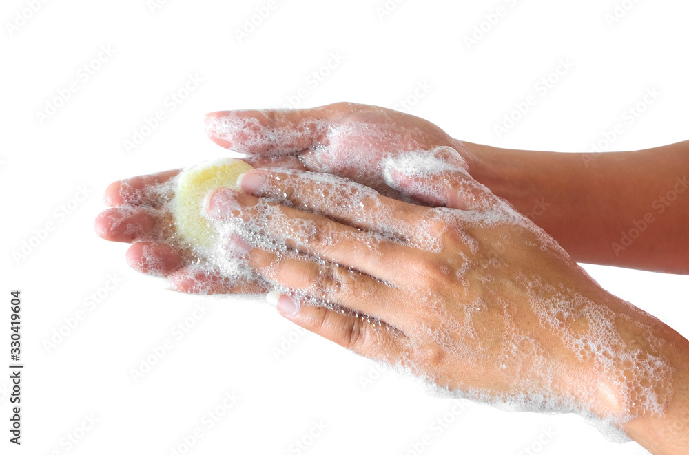 Hands of beautiful women wash their hands with foam to wash the skin and the water flows through the hands, protecting against germs and viruses on the hands. on a white background Health and beauty