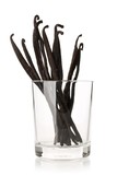 Bundle of dried bourbon vanilla beans or pods in glass over white